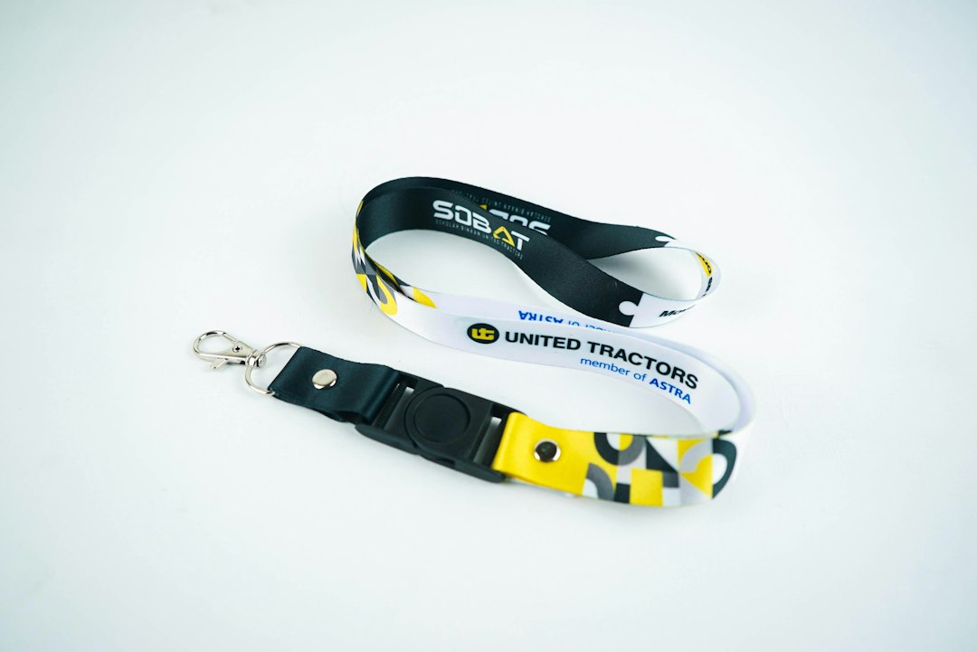 Two lanyards with united tractors logo on white background