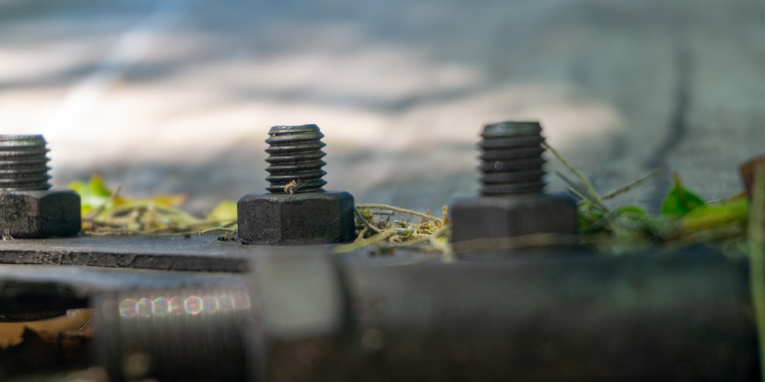 A couple of screws sitting on top of a street