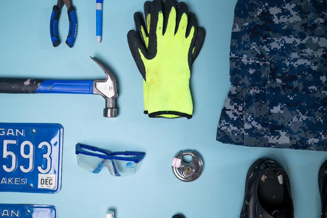 Tools and safety gear arranged on a blue surface
