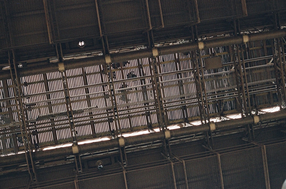 Industrial ceiling with exposed pipes and metal grid