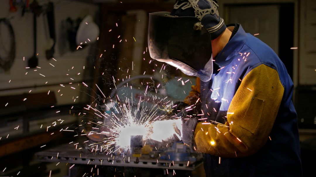 a man wearing a blue protective gear working on a machine